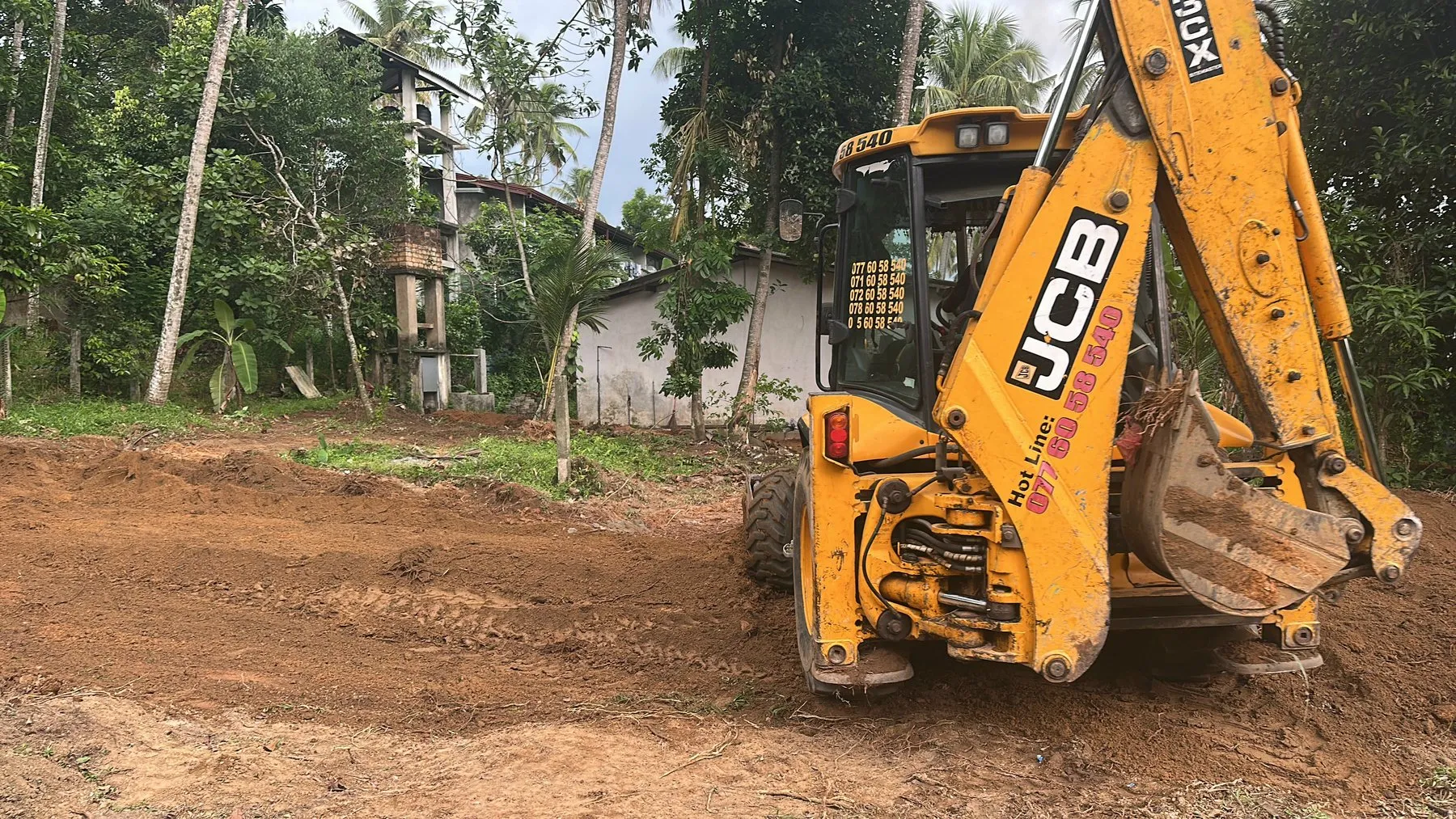 A JCB levelling the plot